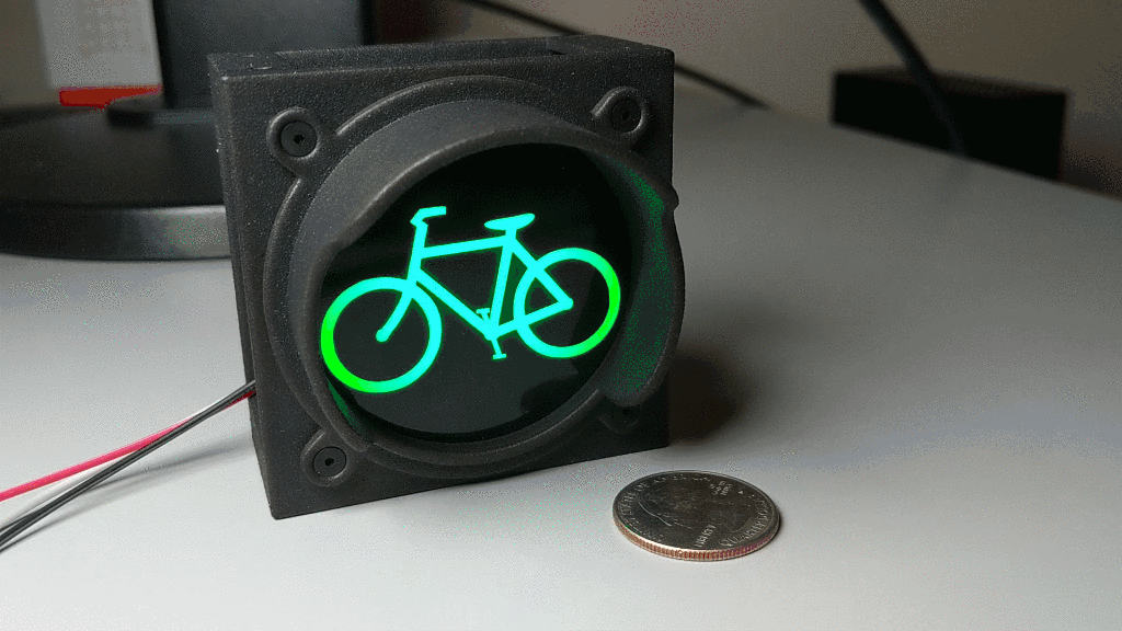 Completed bicycle traffic signal cycling through traditional traffic light colors.