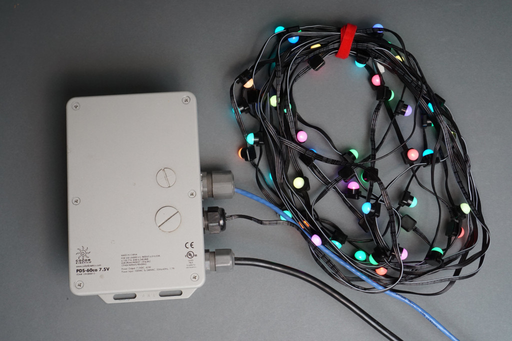 An iColor Flex SL setup. DMX data feeds into power data supply then power data supply connects to nodes using an integrated twenty foot leader cable.