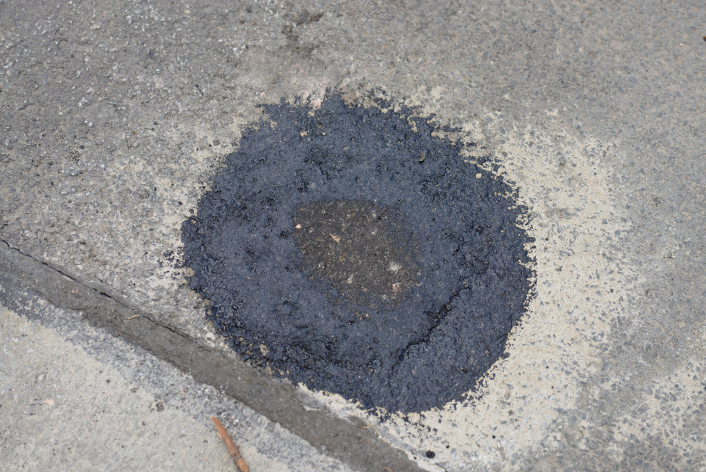 Finished asphalt repair of a hand hole dug four months ago.