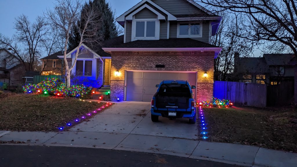 The lights placed in the grass on each side of the driveway.