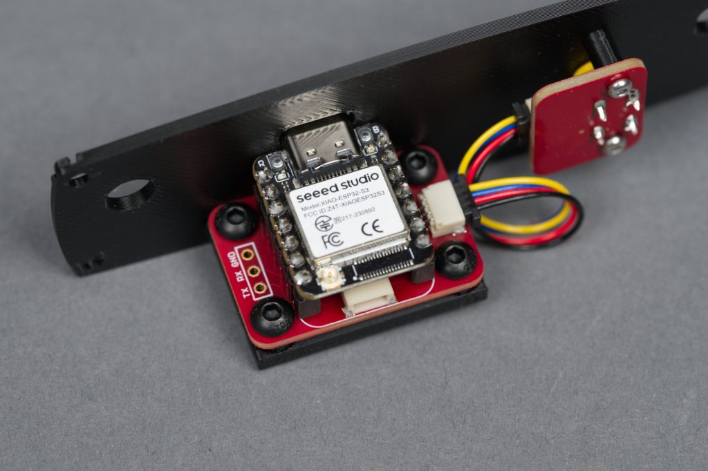 This board holds the XIAO ESP32-S3 dev board in place and converts the QWIIC interface to +5V power and logic.