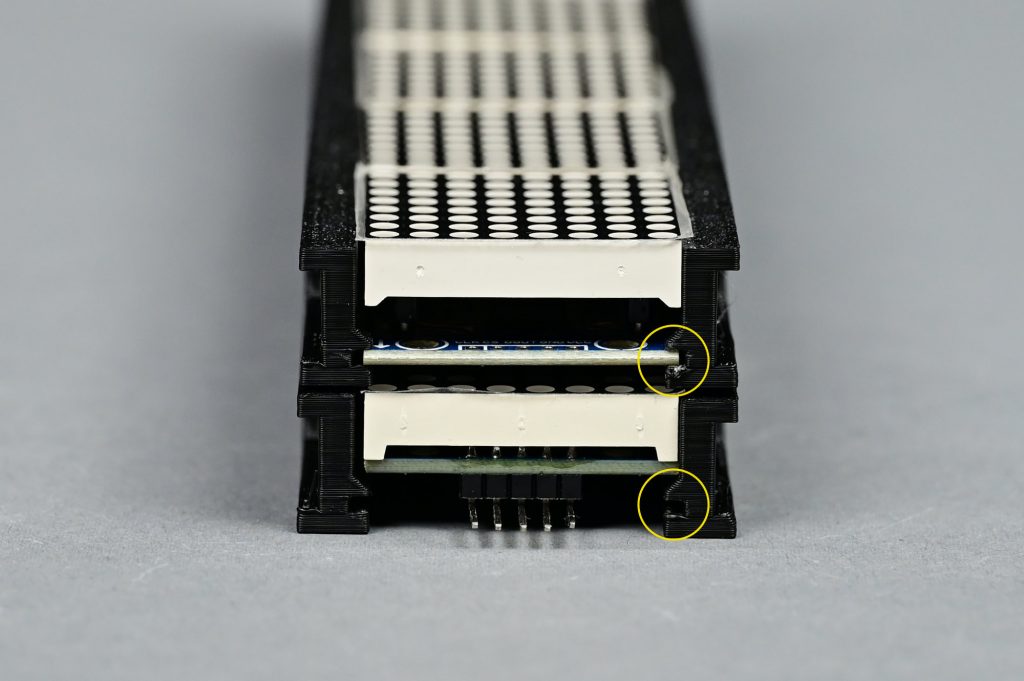 Top is a socketed LED module Bottom is an unsocketed LED module. The grooves in the 3D print capture the top module. The bottom module is just resting on the print and will fall out when stood up.