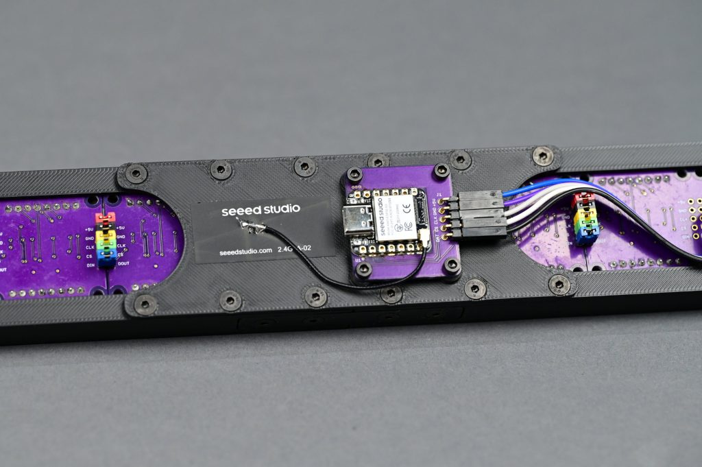 The controller board mounted to the back plate on the completed unit.