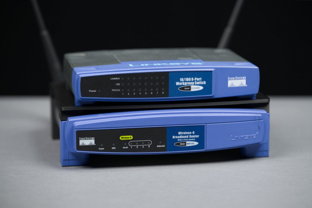 A short stack of Linksys networking products.