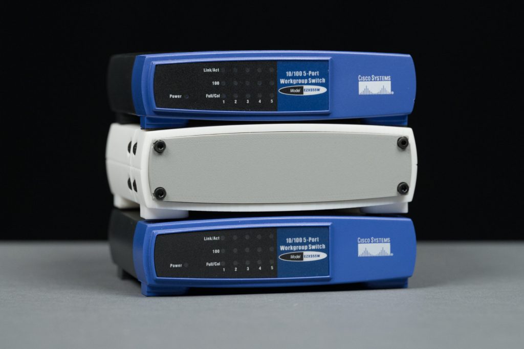 A stackable version of the enclosure sandwiched between two 5-port workgroup switches. 
